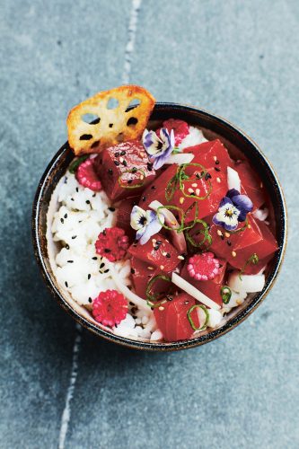 Eine traditionelle Poke-Bowl mit Thunfisch, Reis, frittierter Lotuswurzel, eingelegtem Maiskolben und essbaren Blüten. Foto: Matt Russell/Hardie Grant Publishing